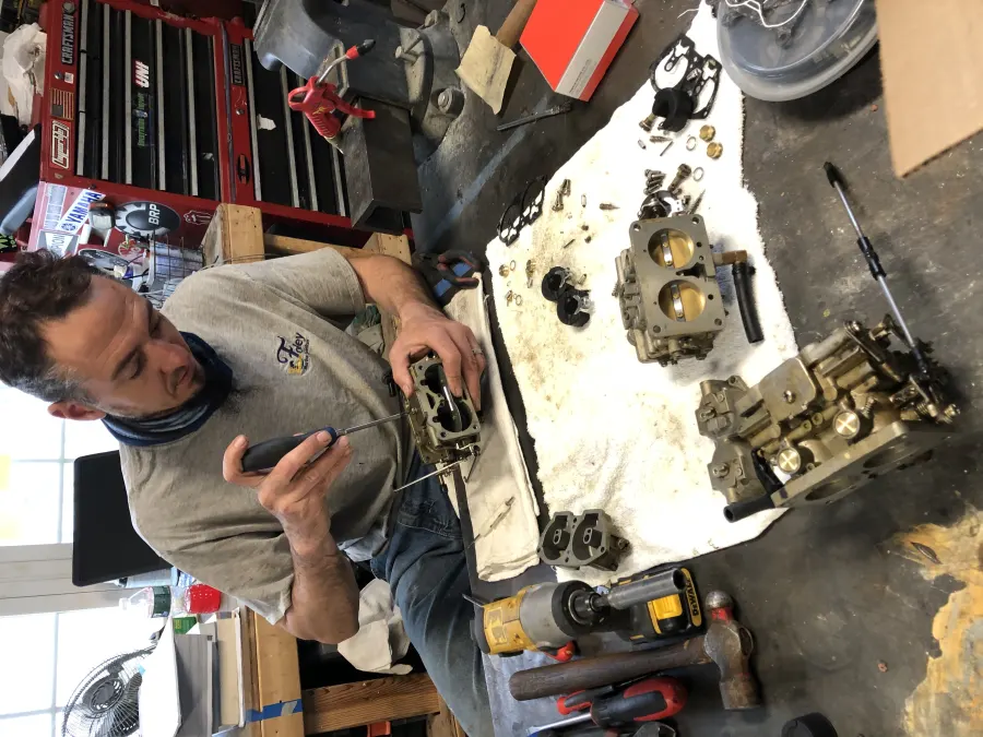 Technician rebuilding an engine part at the bench