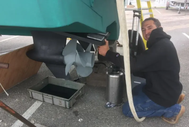 Technician working under a hull
