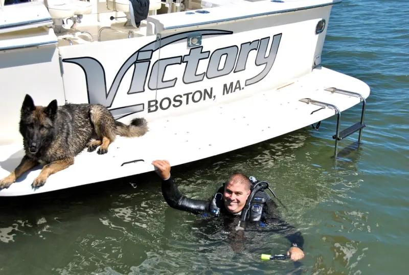 Diver beside a boat stern