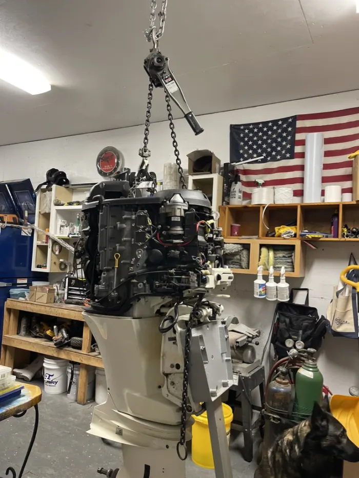 Outboard engine on a hoist in the shop